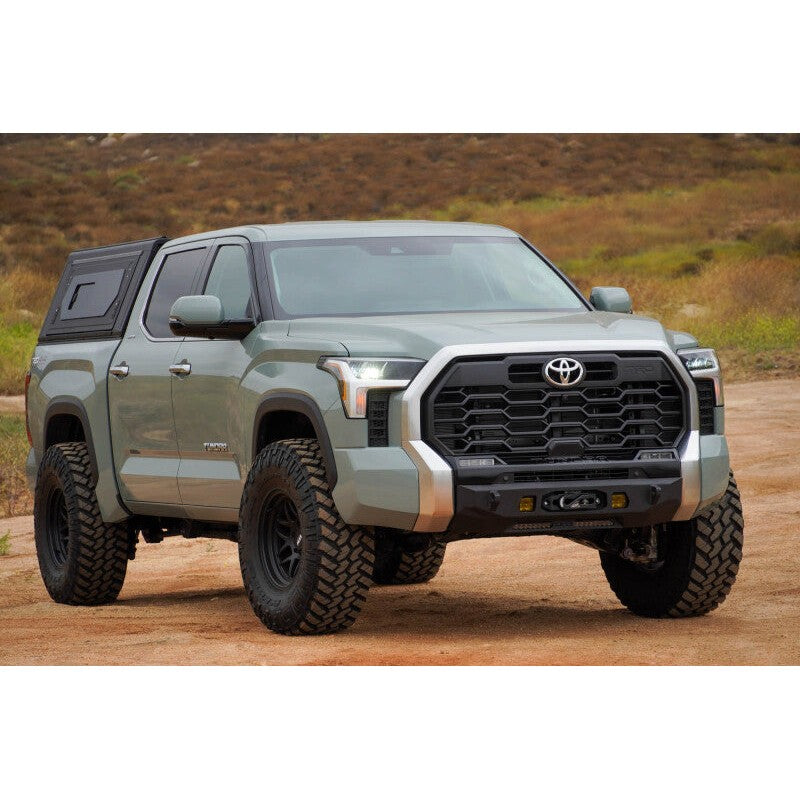 Low-profile black DV8 Centric Series front bumper with hidden winch mount on a 2022-2026 Toyota Tundra.