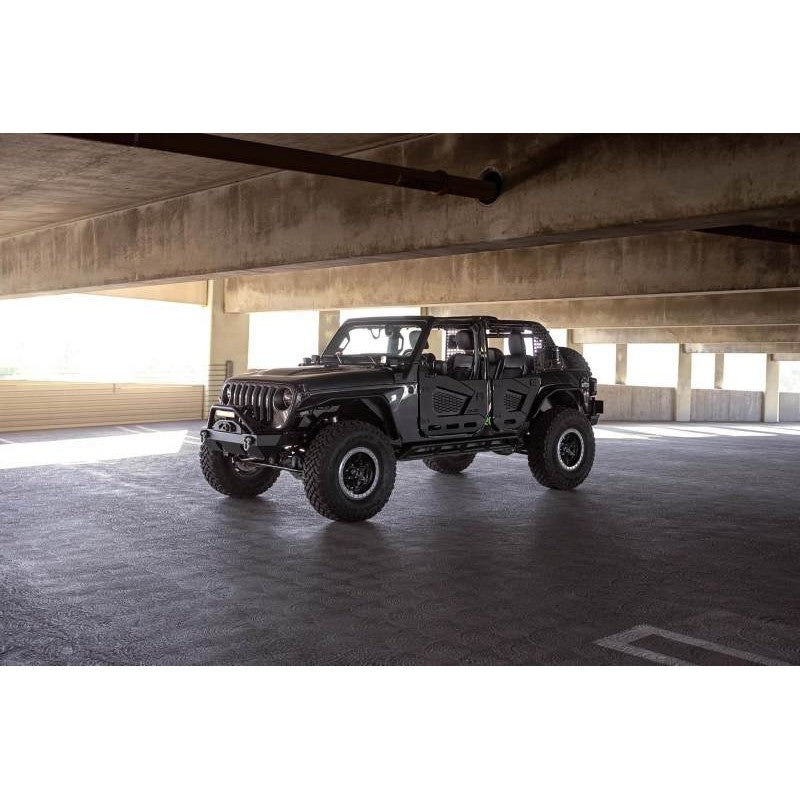 DV8 Offroad FS-15 Series black powder-coated stubby front bumper with bull bar and winch mount for Jeep Wrangler.