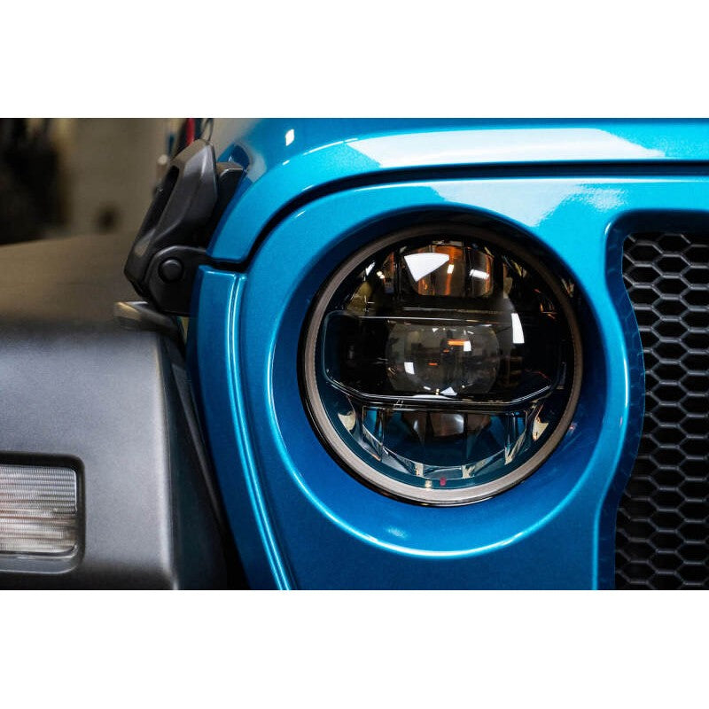 DV8 Offroad 9-inch LED projector headlights with black inner bezels and aluminum housings for Jeep Wrangler and Gladiator.