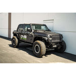 DV8 Offroad micro-texture black OE Plus side steps mounted to the pinch weld of a Jeep Wrangler JL 4-door