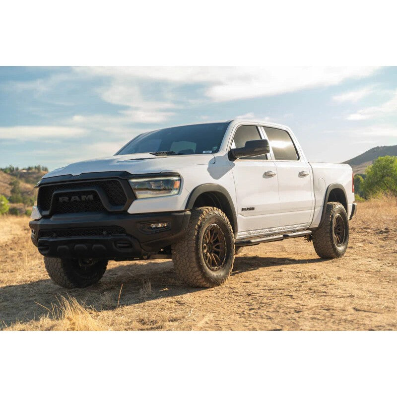 DV8 Offroad SRDR1-01 OE Plus black steel side steps installed on a Ram 1500 Crew Cab.
