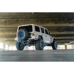 DV8 Offroad FS-15 high-clearance rear bumper with micro-texture black powder coat on a Jeep Wrangler JL.