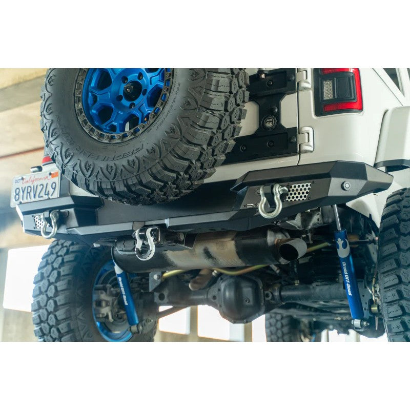DV8 Offroad MTO Series black full-width rear bumper for 2018-2025 Jeep Wrangler JL with light pod mounts and shackle tabs.