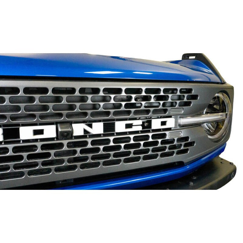 Black powder coated steel DV8 Offroad adaptive cruise control relocation bracket for 2021-2026 Ford Bronco.