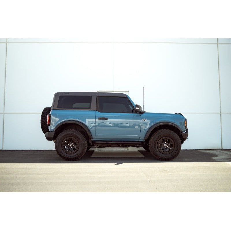 DV8 Offroad black powder-coated steel pinch weld covers with laser-cut logo installed on a 2021-2025 Ford Bronco.
