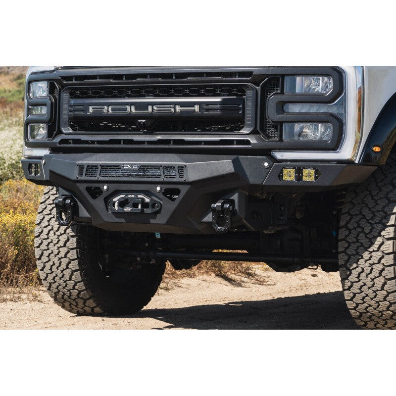 DV8 Offroad Spec Series micro-texture black winch front bumper with satin black accents for 2023-2026 Ford Super Duty.