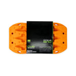 A pair of stackable orange DV8 Offroad Xtract Mini traction boards featuring molded handles and mounting holes.