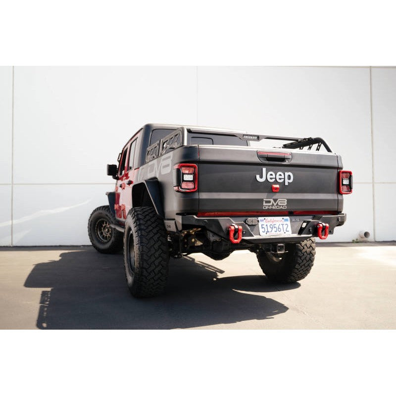 Red powder-coated DV8 Offroad Elite Series forged steel D-ring shackles with flush chromoly pins and black isolators.