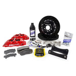 EBC Racing Apollo-4 front big brake kit featuring blue 4-piston calipers, 330mm rotors, and braided stainless steel lines.