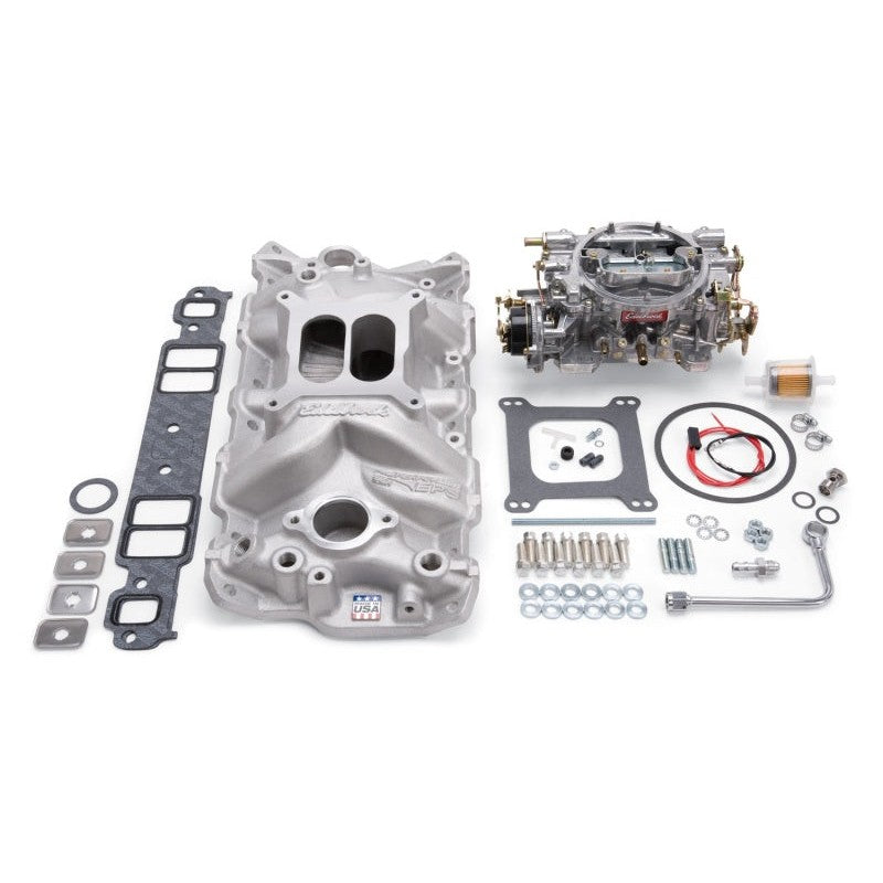 Edelbrock 2021 Performer EPS intake manifold and carburetor kit in natural finish with gaskets and mounting hardware.