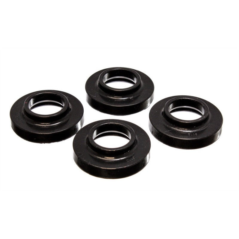 Set of four black Energy Suspension Hyper-Flex polyurethane coil spring lift isolators for Jeep vehicles.