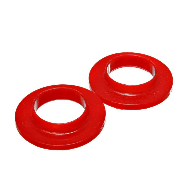 Two red Energy Suspension 9.6118R polyurethane coil spring isolators with a 2.125 inch inner diameter.