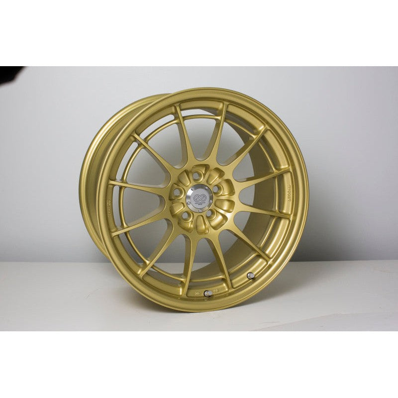 Enkei NT03+M Gold multi-spoke performance wheel with perimeter brace ring and 18x9.5 dimensions.