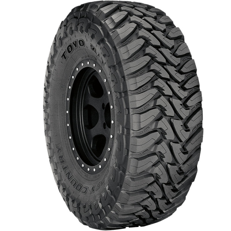 Toyo Open Country M/T mud-terrain tire featuring aggressive hook-shaped tread blocks and deep shoulder lugs.