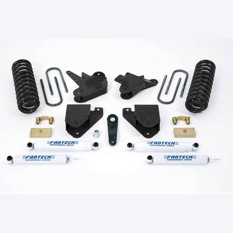 Fabtech K2098 6-inch lift system components including white performance shocks, coil springs, and black relocation brackets.
