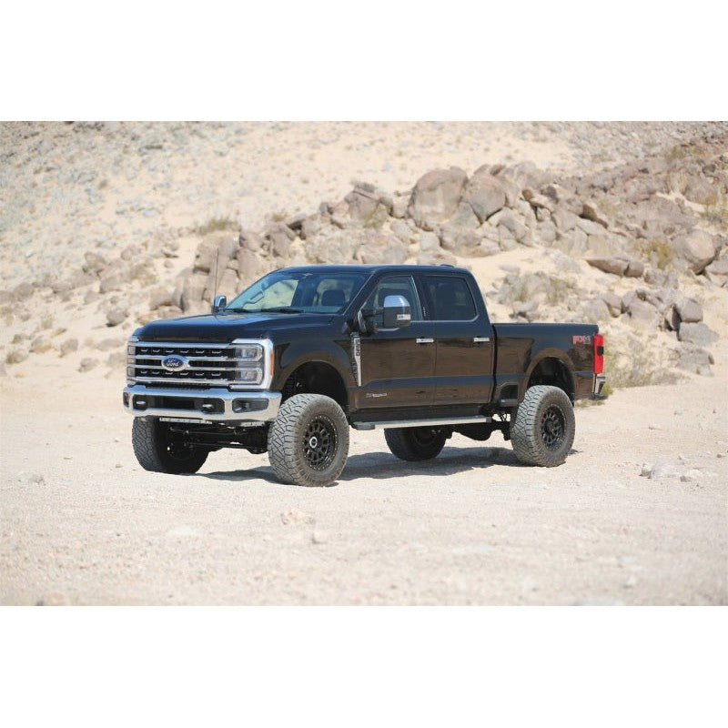 Pair of Fabtech 6-inch lift front coil springs in a black powder-coated finish for Ford Super Duty trucks.