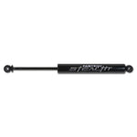 Fabtech Stealth all-black monotube rear shock absorber with raised metal nameplate and matte black piston rod.