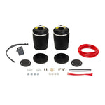 Firestone Ride-Rite rear air spring kit with two rubber bellows, steel mounting brackets, and air lines.
