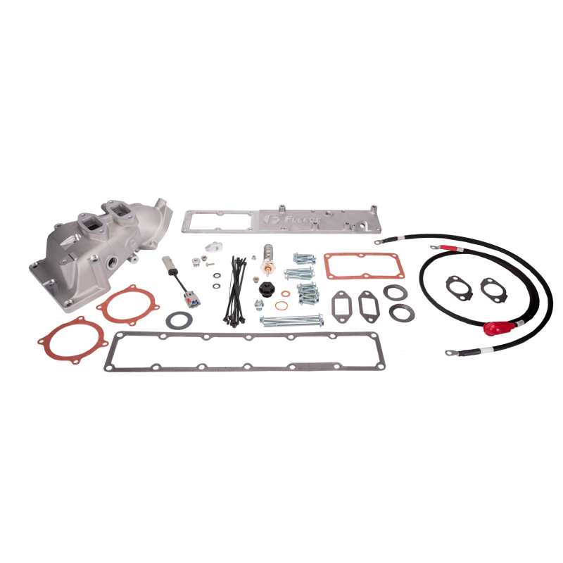 Fleece Performance grid heater and intake upgrade kit with gaskets, labeled hardware, and booted electrical cables.