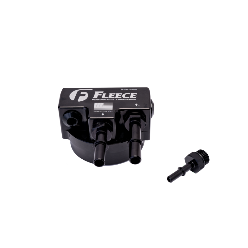 Anodized black billet aluminum fuel filter bypass block with quick-disconnect fittings for 6.7L Powerstroke engines.