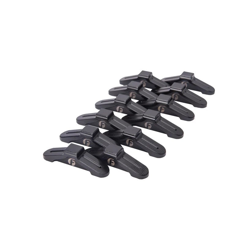 Set of 12 Fleece Performance billet steel rocker arm bridges for Dodge Cummins 24V 5.9L and 6.7L engines.