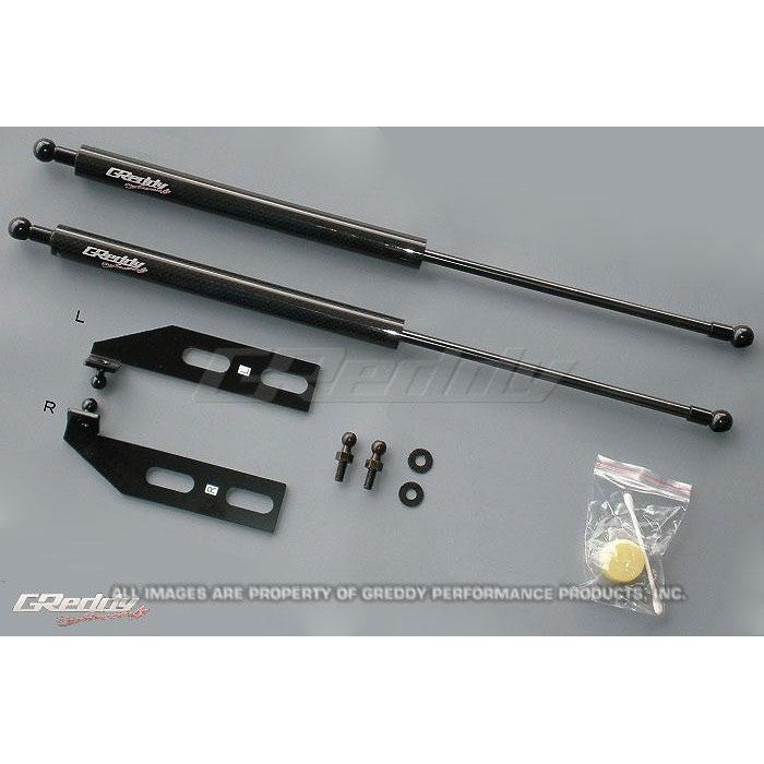 GReddy engine hood lifter kit with gas-charged dampers and mounting brackets for 1993-1995 Mazda RX-7 FD3S.