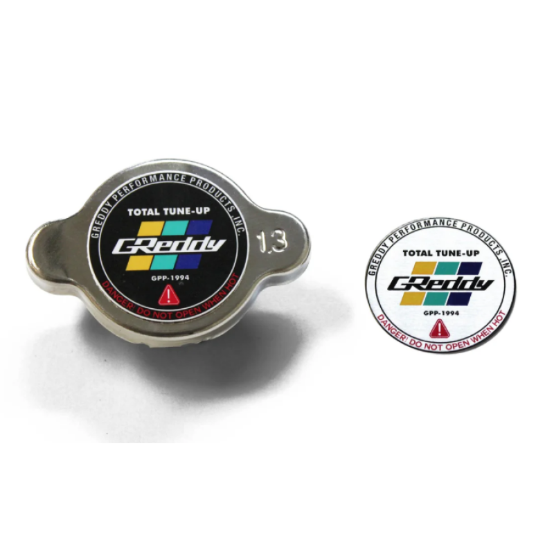 Polished metal GReddy Type-S radiator cap featuring 1.3 kg/cm2 pressure rating on the center badge.