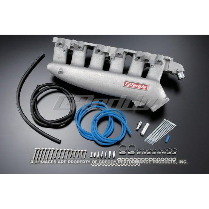 Silver cast aluminum GReddy plenum intake manifold for Nissan RB25DET ECR33 engines.