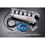 Silver cast aluminum GReddy plenum intake manifold for Nissan RB25DET ECR33 engines.