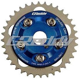 GReddy adjustable cam sprocket with blue anodized center and silver outer gear for Toyota 1JZ and 2JZ engines.