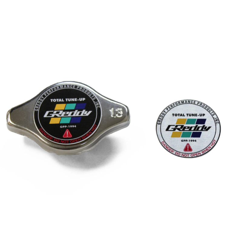 Polished GReddy Type-N 1.3 high-pressure radiator cap with blue and yellow GReddy logo badge.