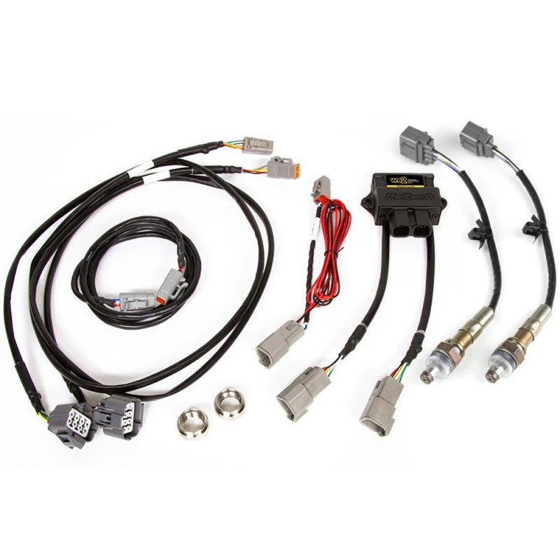 Haltech WB2 dual channel wideband controller unit shown with two NTK oxygen sensors, CAN cable, and weld-in bungs.