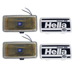 Pair of rectangular Hella 550 Series amber fog lamps with black ABS housings and universal mounting brackets.