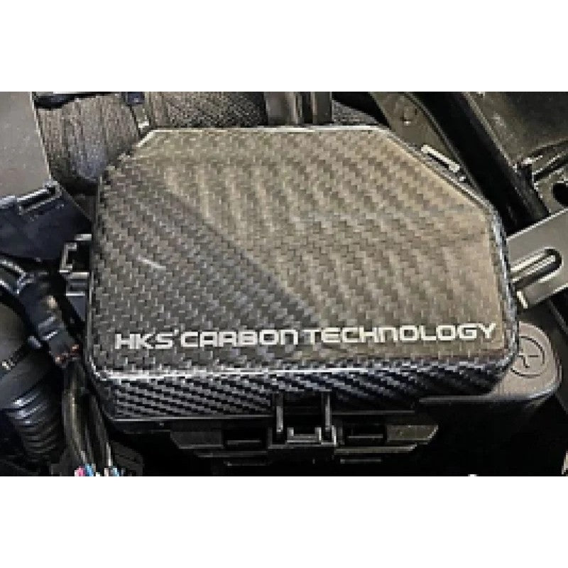 HKS dry carbon fiber fuse box cover featuring a matte twill weave for the 2023 Nissan Z engine bay