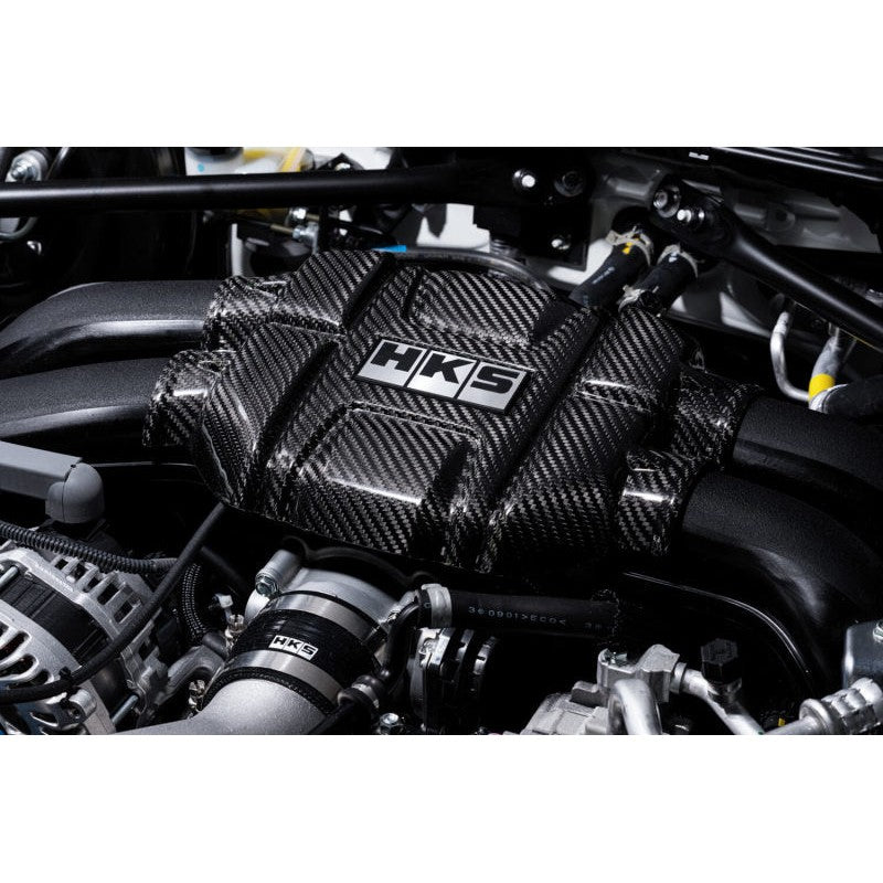 HKS dry carbon engine cover in twill weave carbon fiber for Toyota GR86 and Subaru BRZ.
