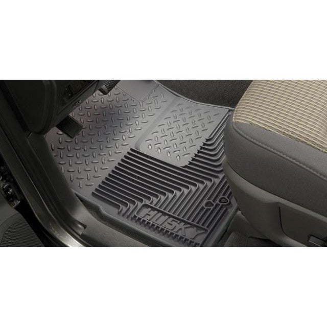 Black Husky Liners Heavy Duty front floor mats with deep debris channels and rubberized DuraGrip material.