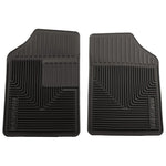 A pair of black Husky Liners 51051 Heavy Duty front floor mats with center liquid channels and StayPut Cleats.