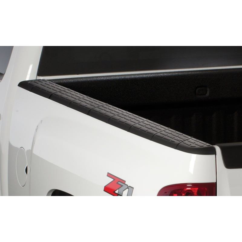 Black custom-molded Husky Liners Quadcaps bed rail caps with removable stake pocket covers for Chevrolet Silverado.