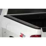 Black custom-molded Husky Liners Quadcaps bed rail caps with removable stake pocket covers for Chevrolet Silverado.