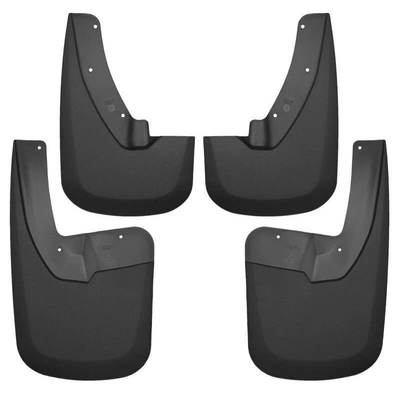 Four black Husky Liners FormFit mud guards for front and rear wheel wells of a Dodge Ram truck.