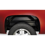 Husky Liners black impact-resistant thermoplastic rear wheel well guards for GMC Sierra 1500, 2500, and 3500 trucks.