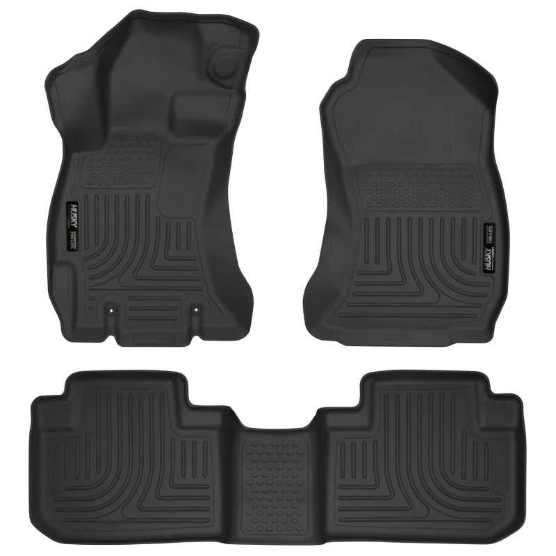 Black Husky Liners Weatherbeater floor mats for front and second row seating of a 2014-2018 Subaru Forester.