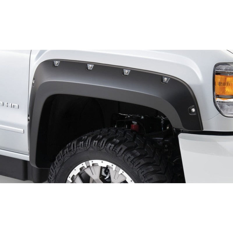 Four-piece set of matte black Husky Liners Pocket Style Fender Flares with decorative stainless steel rivets.