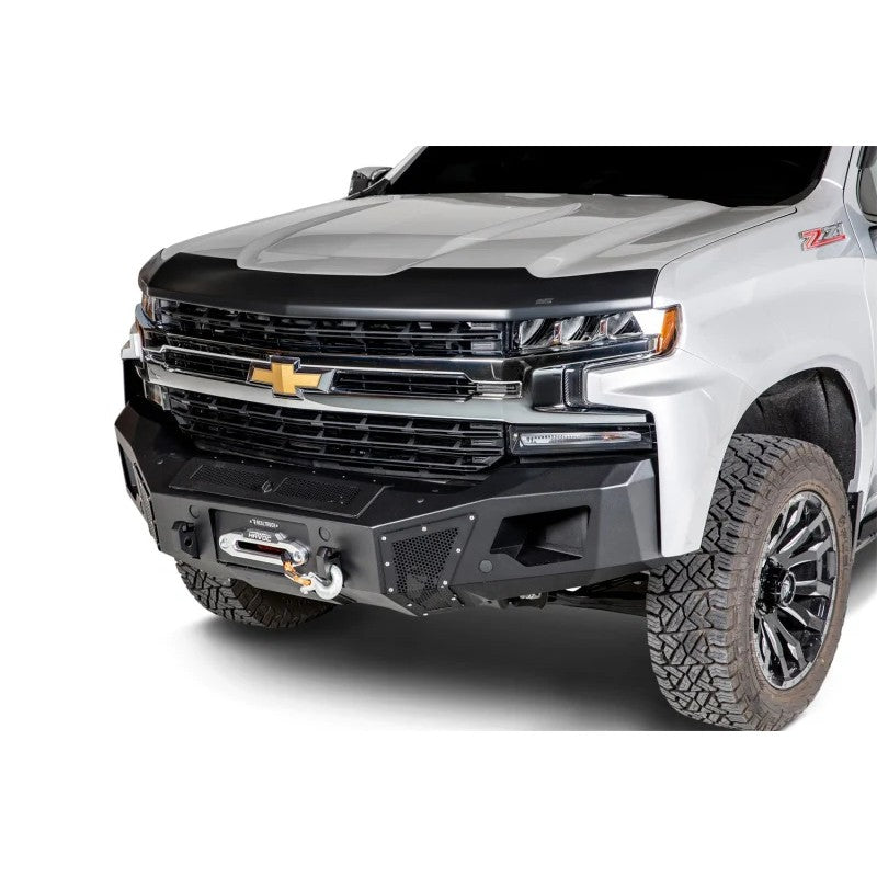 Matte black textured Husky Liners Aeroskin hood protector mounted on the front edge of a Chevrolet Silverado 1500 hood.