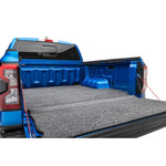 Husky Liners Guardian Comfort charcoal grey bed and tailgate mat installed in a 2017-2026 Ford Super Duty 6.5ft truck bed.