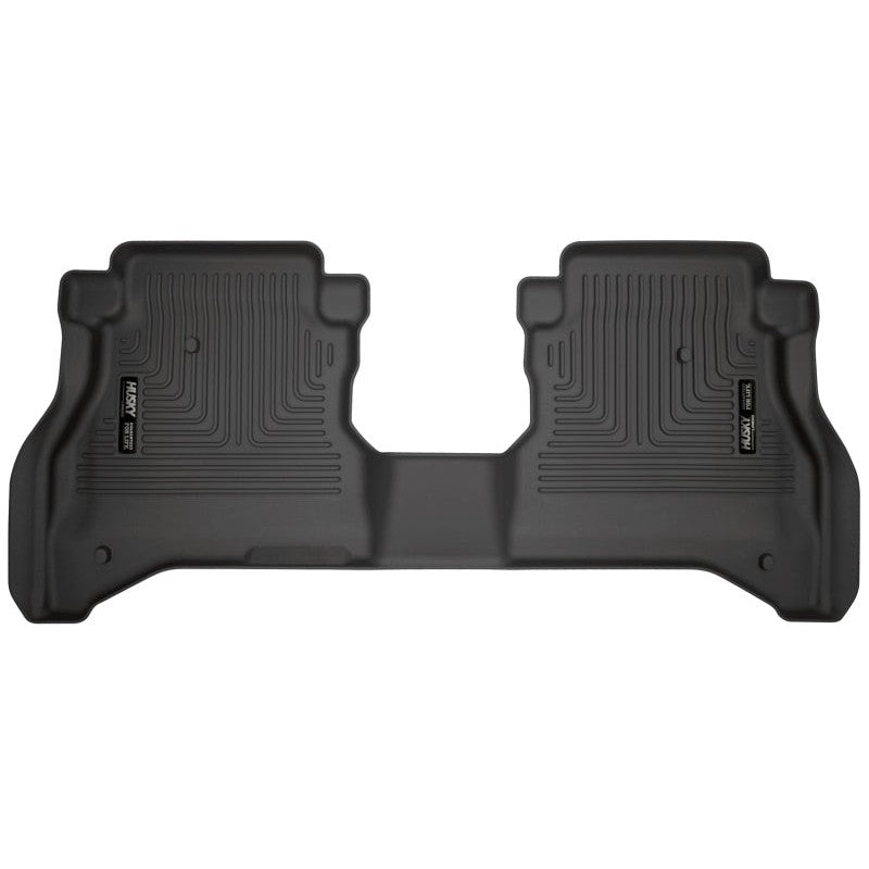 Husky Liners WeatherBeater 2nd seat black floor liners for Jeep Gladiator showing textured surface and StayPut cleats.