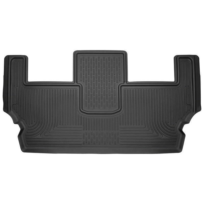Black Husky Liners Weatherbeater 3rd row floor liner with raised FormFit edges and StayPut cleats.