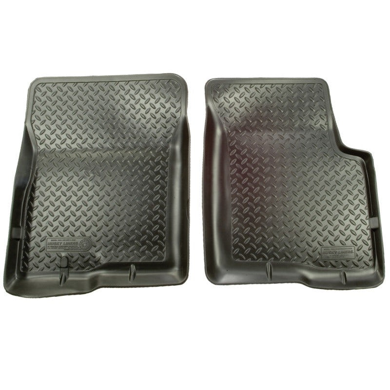 Pair of black Husky Liners Classic Style floor liners with deep grooves and StayPut Cleats for non-slip protection.