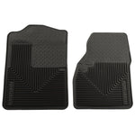 Black Husky Liners Heavy Duty front floor mats featuring raised containment ridges and a reinforced driver heel pad.