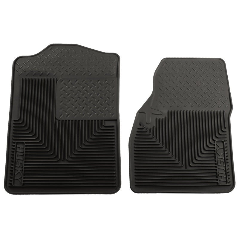 Black Husky Liners Heavy Duty front floor mats featuring raised containment ridges and a reinforced driver heel pad.